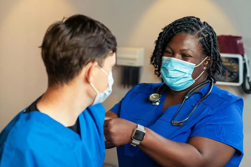 Two healthcare professionals in a German hospital — nursing and dental care are among Germany's most acute shortage professions