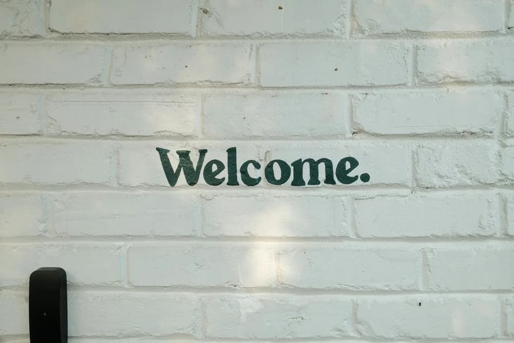 A 'Welcome' sign on a wall — representing the first step into life in Germany through language learning